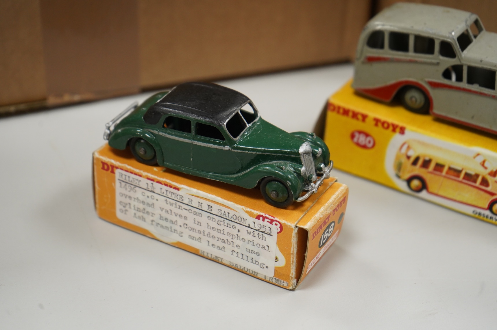 Thirty-two Dinky Toys, all playworn, restored, repainted or overpainted examples in reproduction boxes, including cars and light commercial vehicles